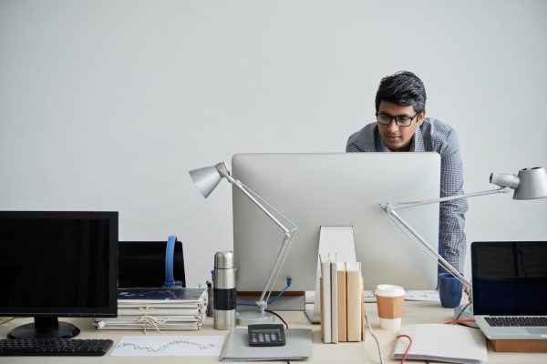 Head engineer checking information on computer monitor